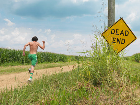 Man Running Along Dirt Roadの写真素材