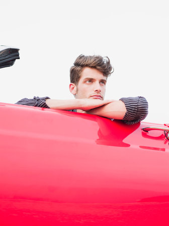 Man Looking Over The Side Of Car Door