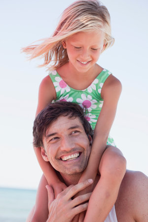 Daughter And Father On Beach Playingの写真素材
