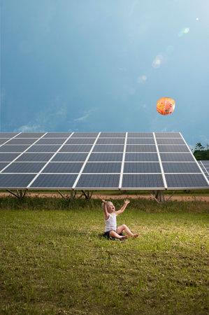 Girl And Balloon In Front Of Solar Panelの写真素材