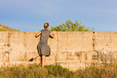 Woman Looking Over Wallの写真素材