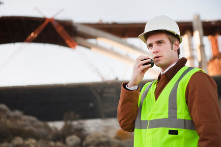 Man At Worksite Using Walking Talkieの写真素材