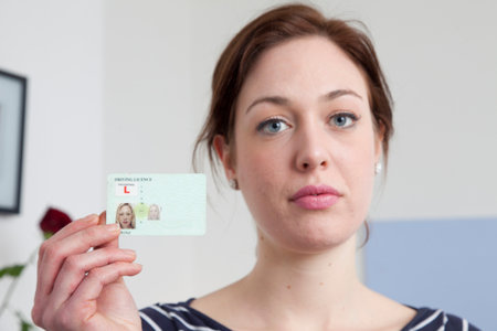 Woman Holding Identification Cardの写真素材