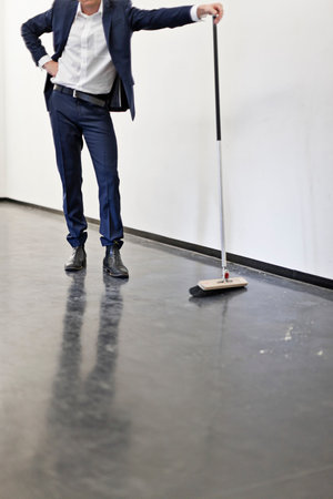 Businessman Sweeping Office Floorの写真素材