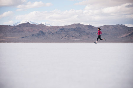 Woman Running In Desert Landscapeの写真素材