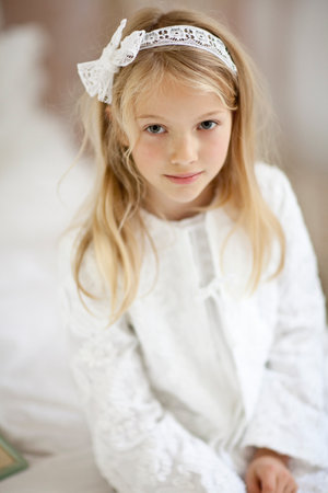 Smiling Girl Sitting On Bedの写真素材