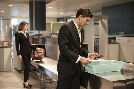 Male Passenger With Personal Belongings In Airport Securityの写真素材