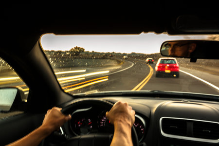 Mid Adult Man Driving Car At Speedの写真素材