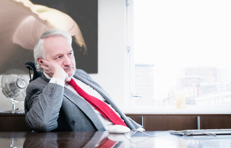 Businessman Leaning On Handの写真素材