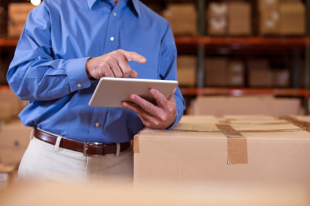 Male Warehouse Manager Using Digital Tabletの写真素材