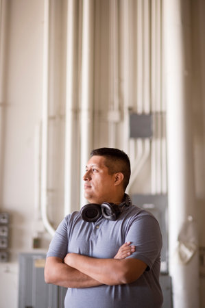 Male Warehouse Worker With Headphones Around Neck