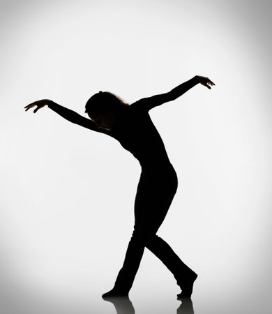 Silhouette Of Woman Dancingの写真素材