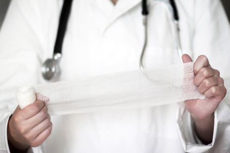 Close Up Studio Shot Of Female Doctor Holding Bandageの写真素材