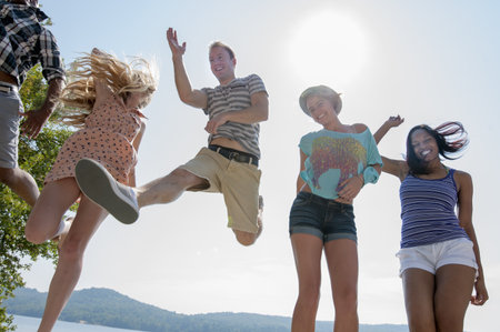 Group Of Friends Wearing Summer Clothes, Low Angleの写真素材