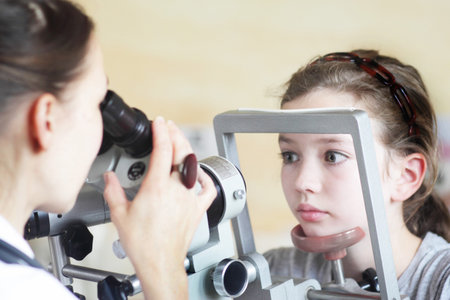 Optometrist Examining Girl's Eyesの写真素材