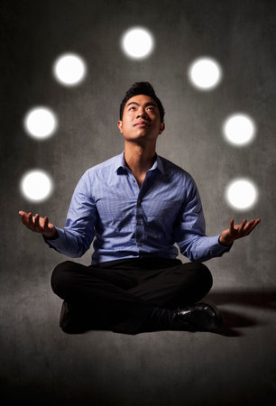 Businessman Juggling Balls Of Lightの写真素材