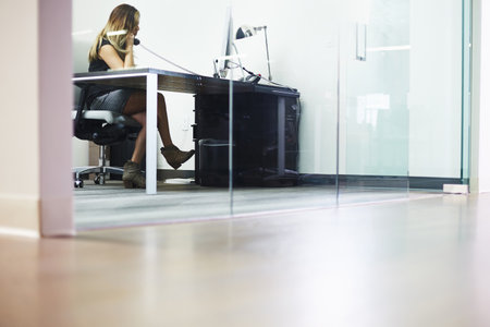 Young Woman On Telephone In Officeの写真素材