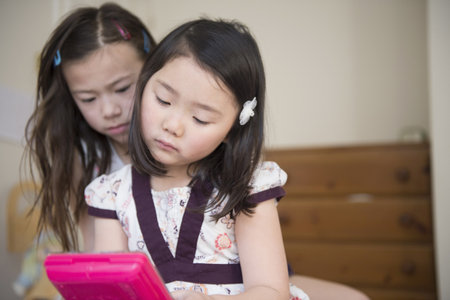 Two Young Female Friends Unhappy With One Computer Gameの写真素材