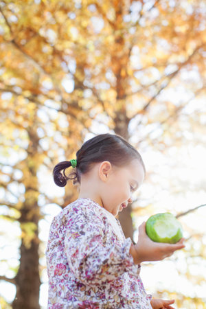 Child Holding Bitten Green Appleの写真素材