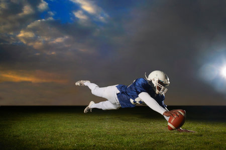 American Football Player Reaching For Touch Downの写真素材