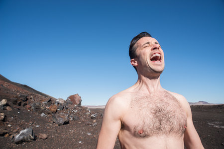 Mid Adult Man Shouting In Desertの写真素材