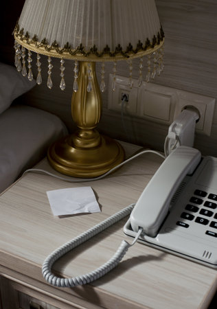 Landline Phone And Blank Note On Hotel Room Bedside Tableの写真素材