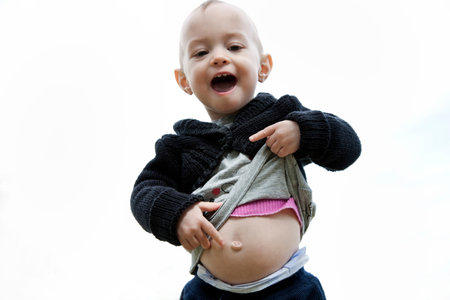 Little Girl Pointing To Her Belly Button