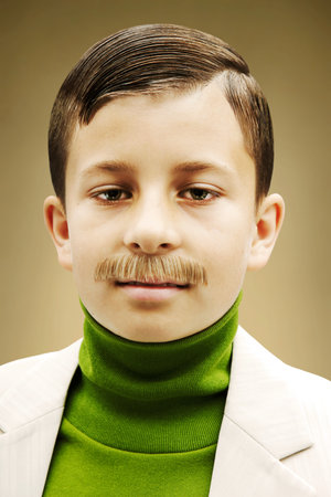 Young Boy Dressed In Beige Suit With Fake Mustacheの写真素材
