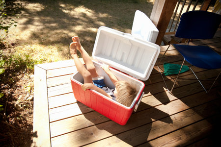Young Boy Sitting In Cool Boxの写真素材