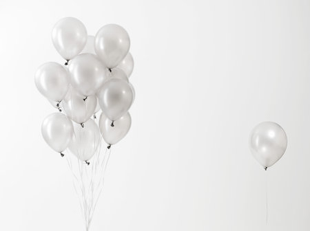 Silver Balloons Floating Against White Backgroundの写真素材