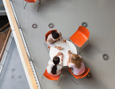 Office Workers Enjoying Meal In Office Cantee, Overhead Viewの写真素材