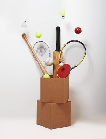 Sports Equipment In A Cardboard Box And In Suspensionの写真素材