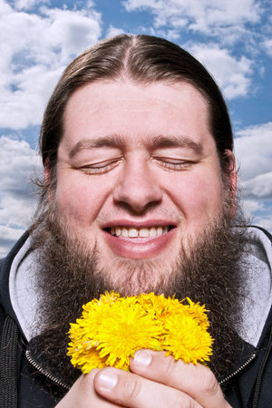Happy Bearded Man With Yellow Flowers
