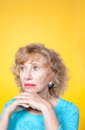 Senior Woman Looking Away With Hands On Chin, Studio Shot