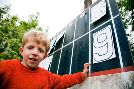 Young Boy Playing With Numbers On Scoreboardの写真素材