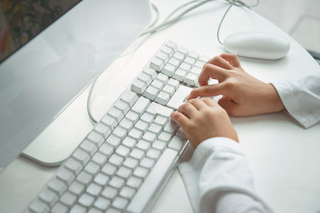 Child Typing On Computer Keyboardの写真素材