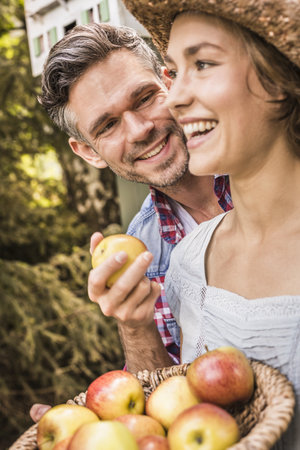 Couple Outdoors, Holding Applesの写真素材
