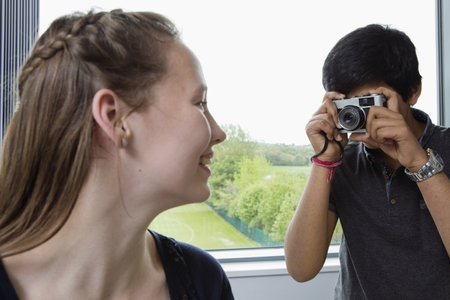 Classmates Taking Photograph In Classroomの写真素材