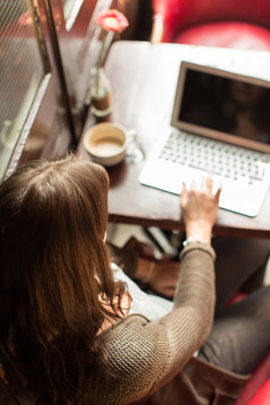 Mid Adult Woman Using Laptop, High Angle Viewの写真素材