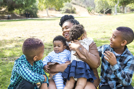 Mother And Children In Parkの写真素材