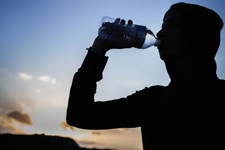 Young Woman Drinking From Water Bottleの写真素材