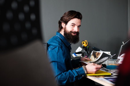 Young Man With Beard At Desk