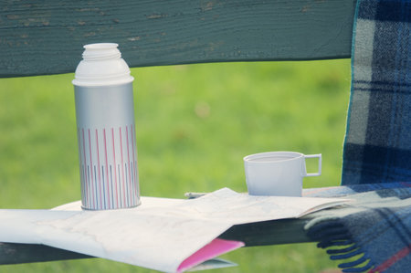 Drinks Flask And Folding Map On Park Benchの写真素材