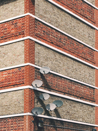 Detail Of Satellite Dishes Attached To Buildingの写真素材