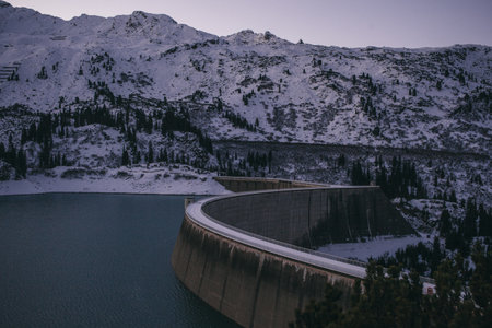 Kops Reservoir Dam And Snow Covered Mountain Range, Evening, Galtur, Austriaの写真素材