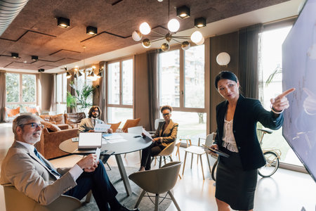 Italy, Businesswoman having presentation in creative studioの写真素材