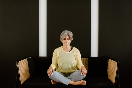 Woman meditating at homeの写真素材