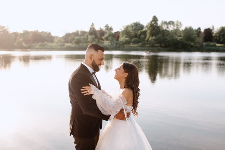 Bride and groom embracing onÃlakeshoreの写真素材