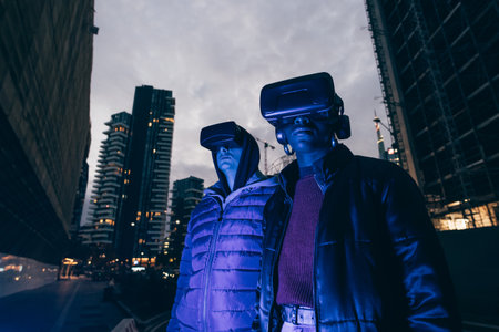 Italy, Couple withÃVRÃgoggles standing in city at duskの写真素材