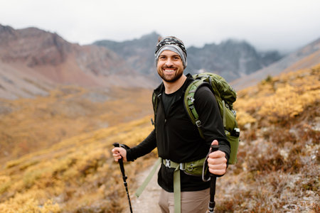 Canada, Yukon, Whitehorse, Portrait of smiling hiker in mountain landscapeの写真素材